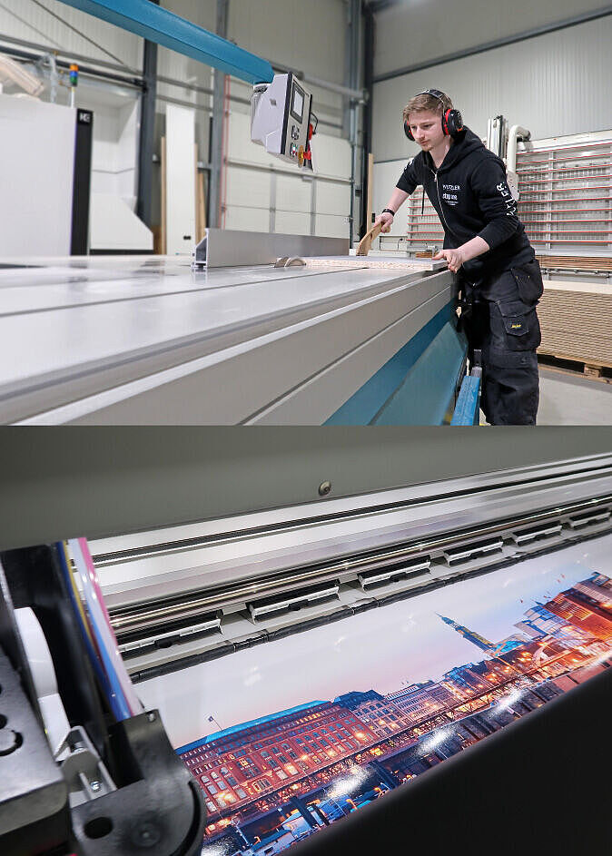 Ein Mitarbeiter in einer Werkstatt arbeitet mit einer großen Schneidemaschine; darunter ein Großformatdruck mit einer Stadtansicht.